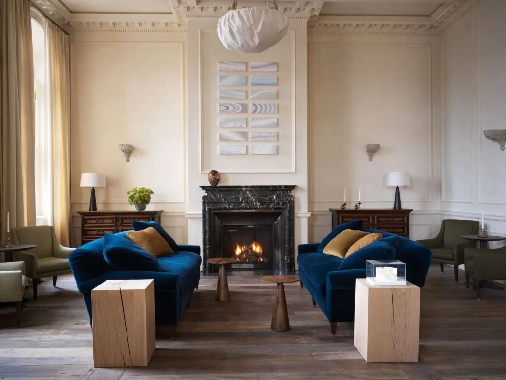 Drawing room with a fireplace and upholstered sofas at San Vicente West Village