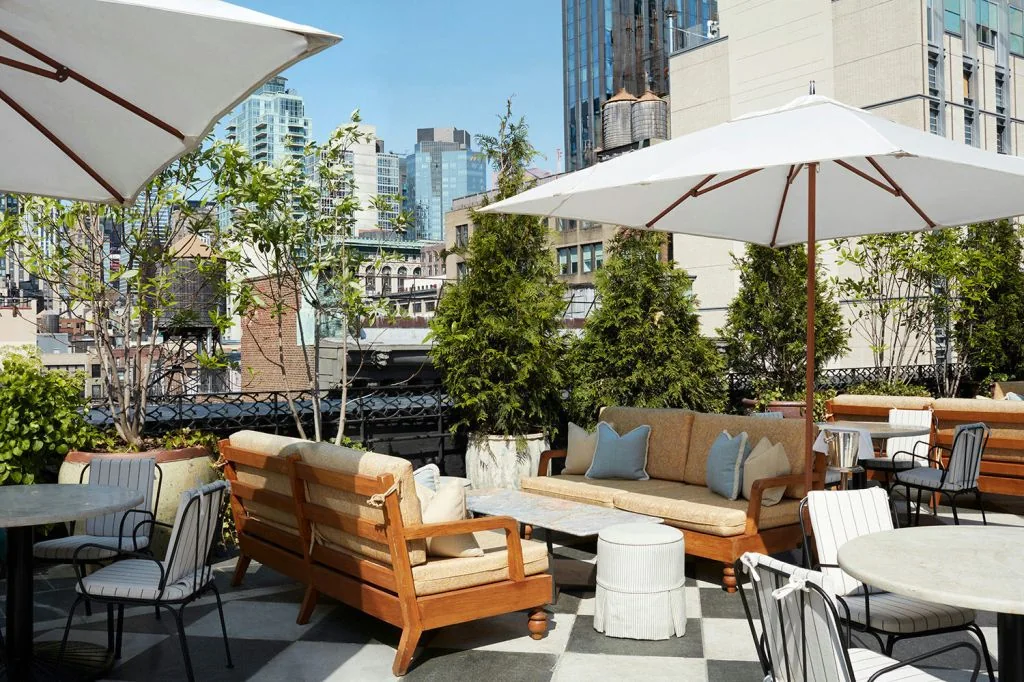 Rooftop seating and white umbrellas at The Ned NoMad in New York